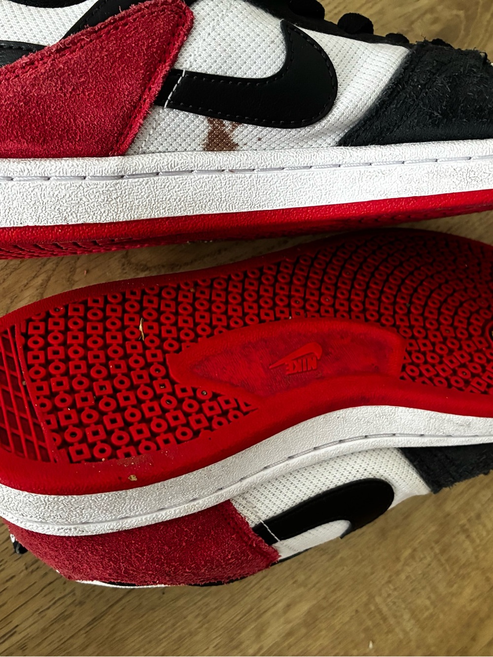 Nike Kids Black, White & Red Low-Top Sneakers there is stain on side of it